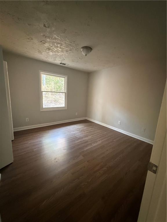 774 Mill Road McDonough, GA 30253 - Photo 18 of 37 an empty room with wooden floor and windows