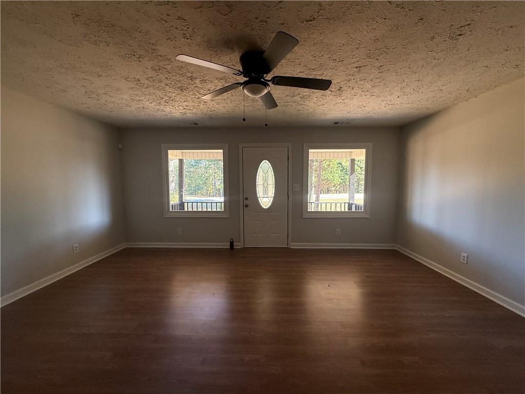 774 Mill Road McDonough, GA 30253 - Photo 4 of 37 an empty room with wooden floor and windows