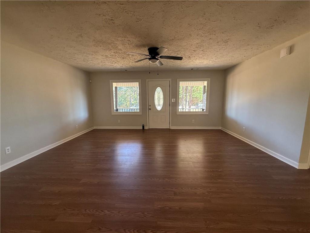 774 Mill Road McDonough, GA 30253 - Photo 5 of 37 an empty room with wooden floor and windows