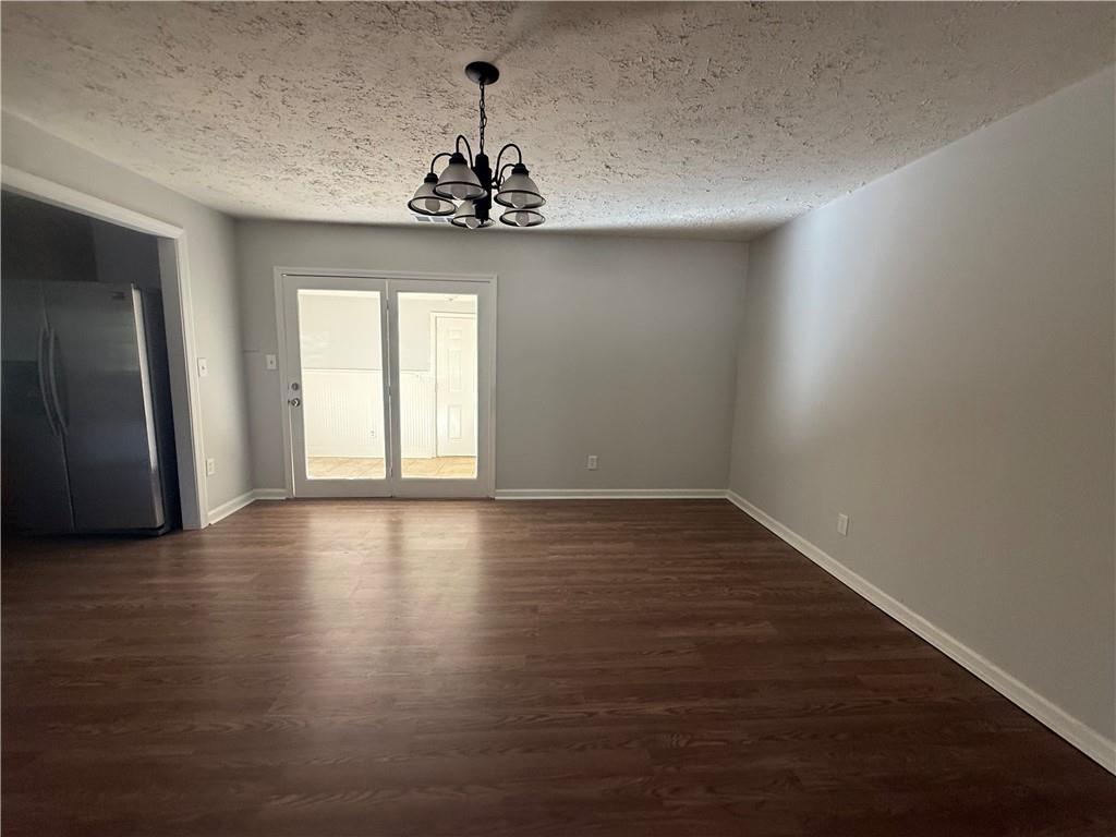 774 Mill Road McDonough, GA 30253 - Photo 6 of 37 a view of an empty room with wooden floor and a window
