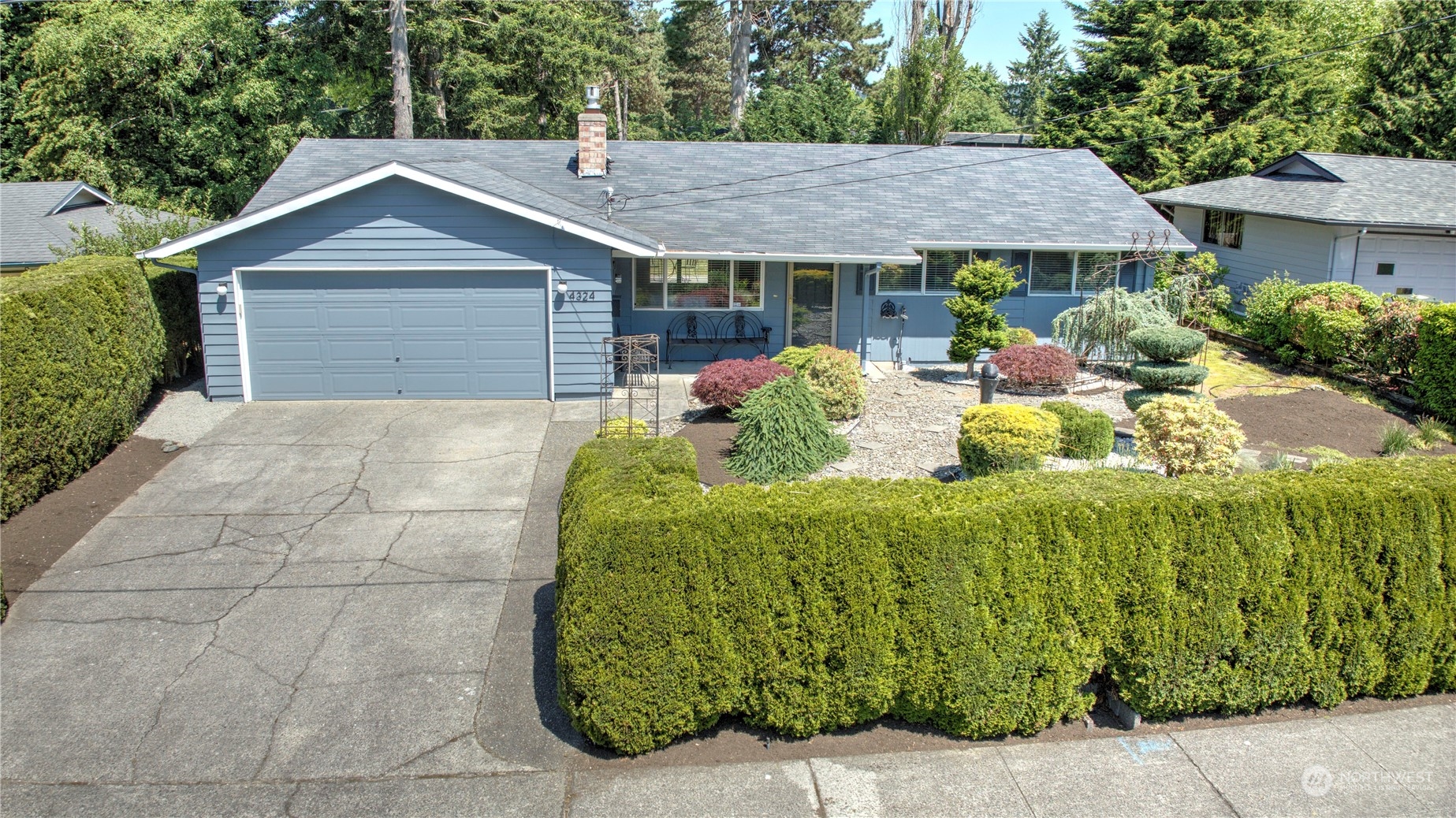 4324 Northeast 11th Street Renton, WA 98059 - Photo 1 of 22 a front view of a house with a garden and plants