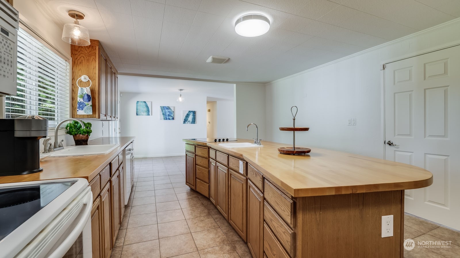 4324 Northeast 11th Street Renton, WA 98059 - Photo 8 of 22 a kitchen that has a sink and a stove in it