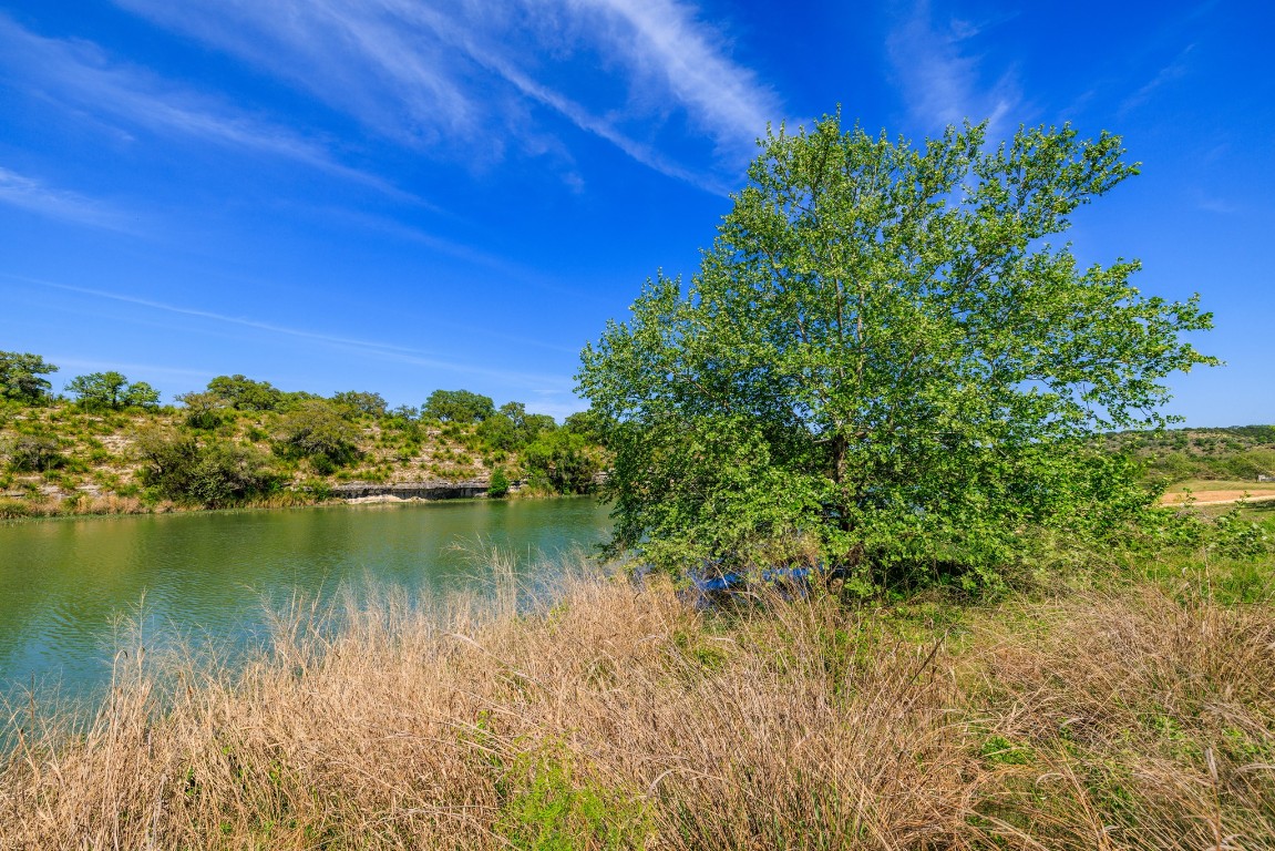 Lot 2 Byrd Ranch Road Johnson City, TX 78636 - Photo 18 of 40 a view of a lake with a house in the background