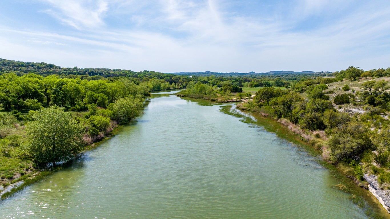 Lot 2 Byrd Ranch Road Johnson City, TX 78636 - Photo 4 of 40 a view of a lake with houses in the back