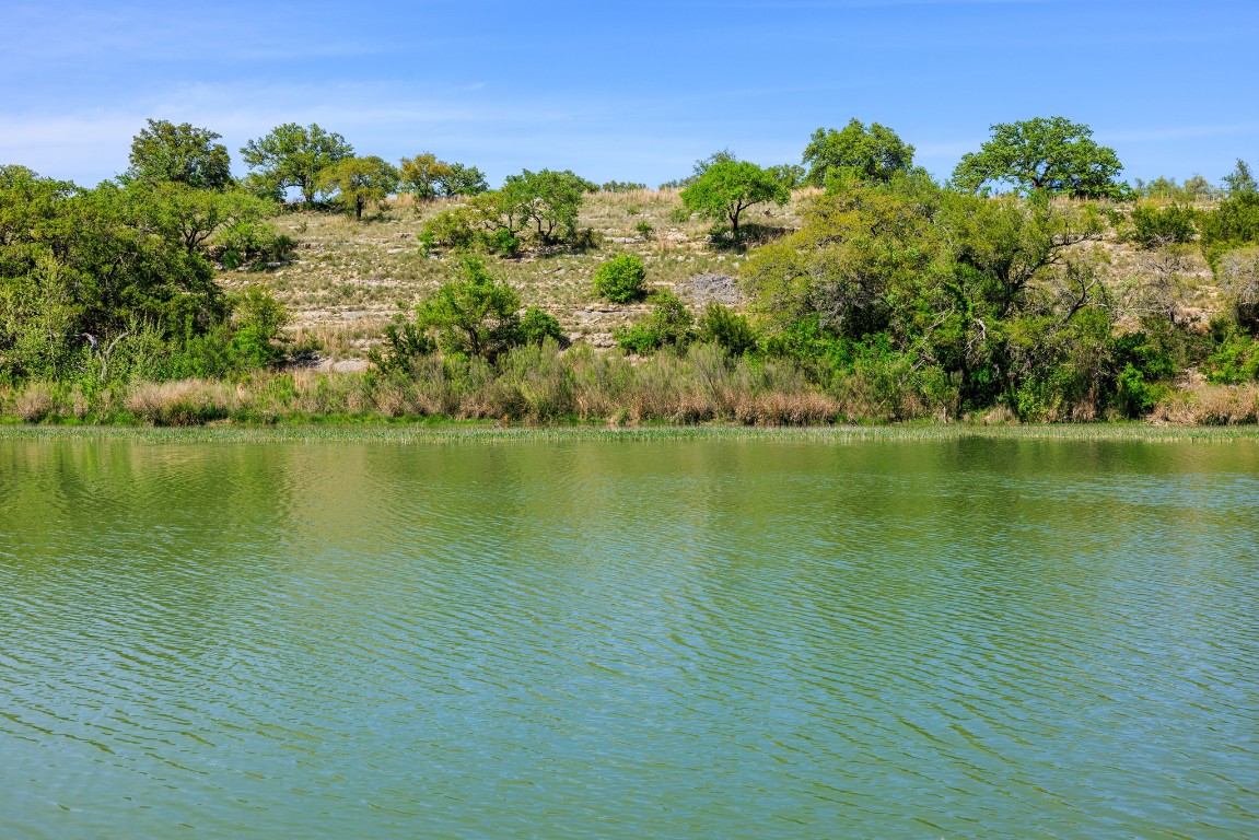 Lot 2 Byrd Ranch Road Johnson City, TX 78636 - Photo 6 of 40 a view of an ocean with a building in the background