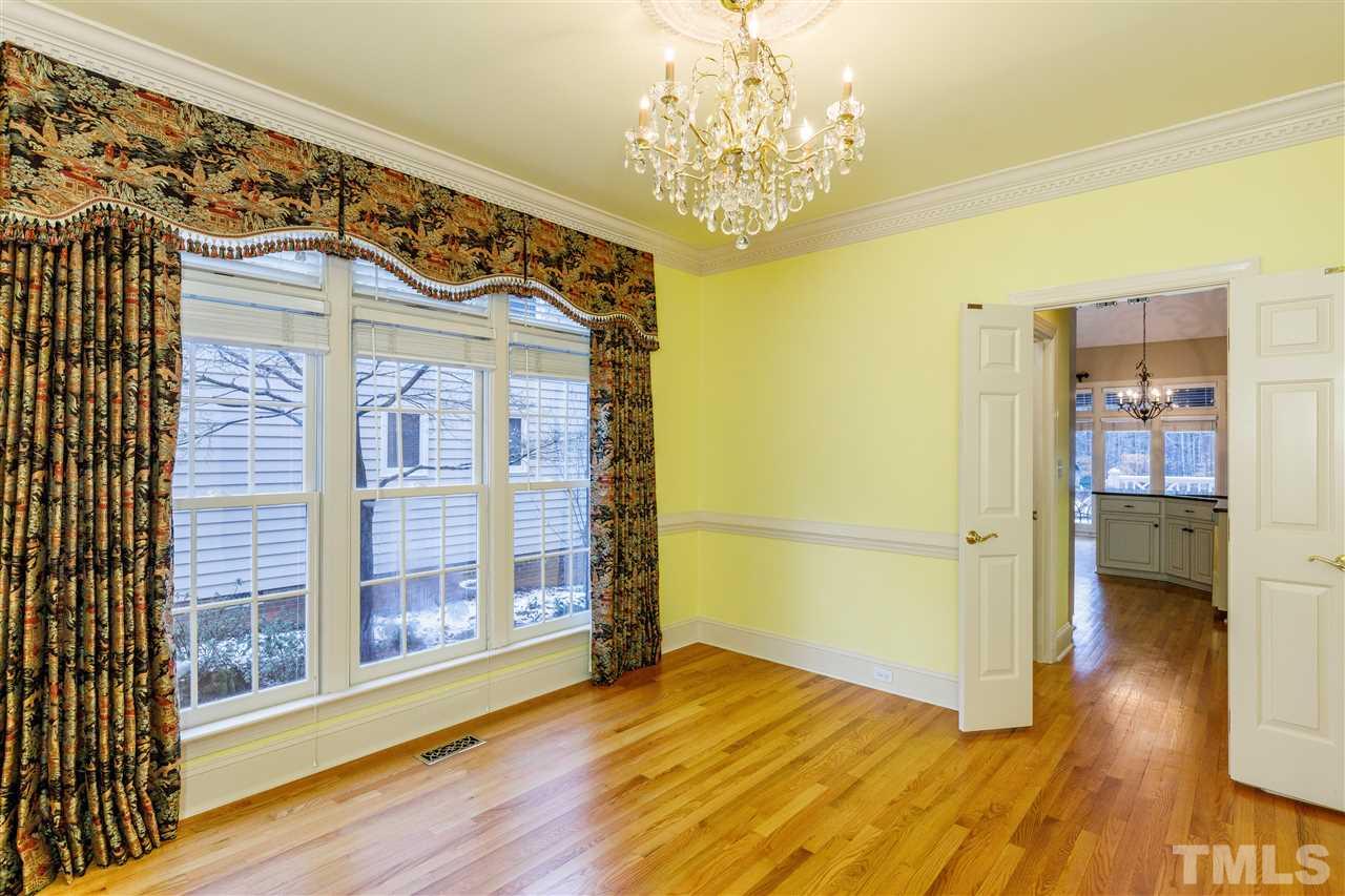 2968 Tillinghast Trail Raleigh, NC 27613 - Photo 11 of 28 a view of a hallway with wooden floor and a chandelier