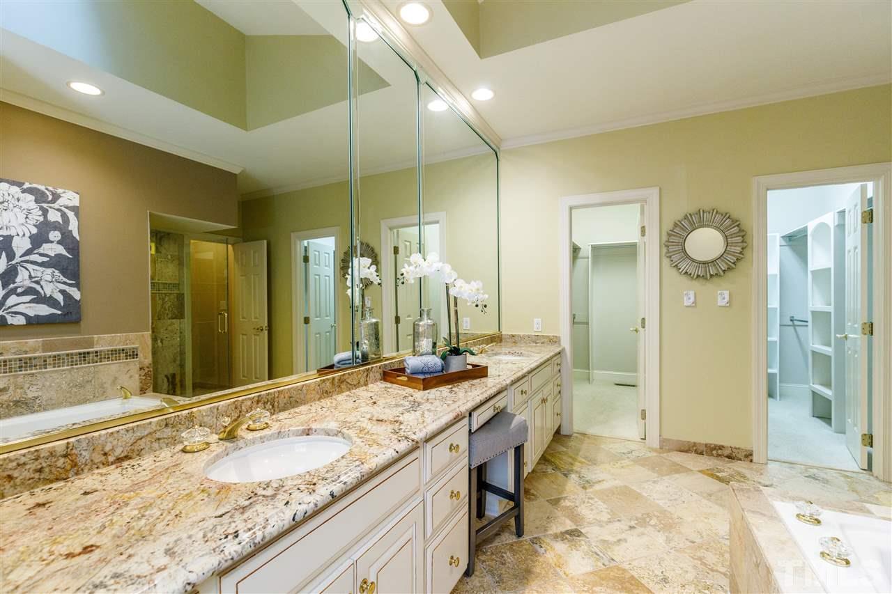 2968 Tillinghast Trail Raleigh, NC 27613 - Photo 15 of 28 a bathroom with a granite countertop sink and a mirror