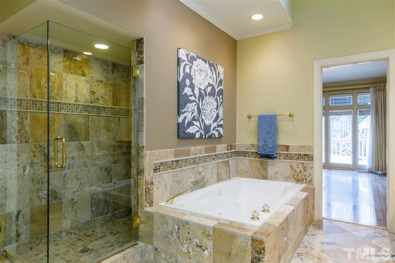 2968 Tillinghast Trail Raleigh, NC 27613 - Photo 16 of 28 a bathroom with a bathtub and shower