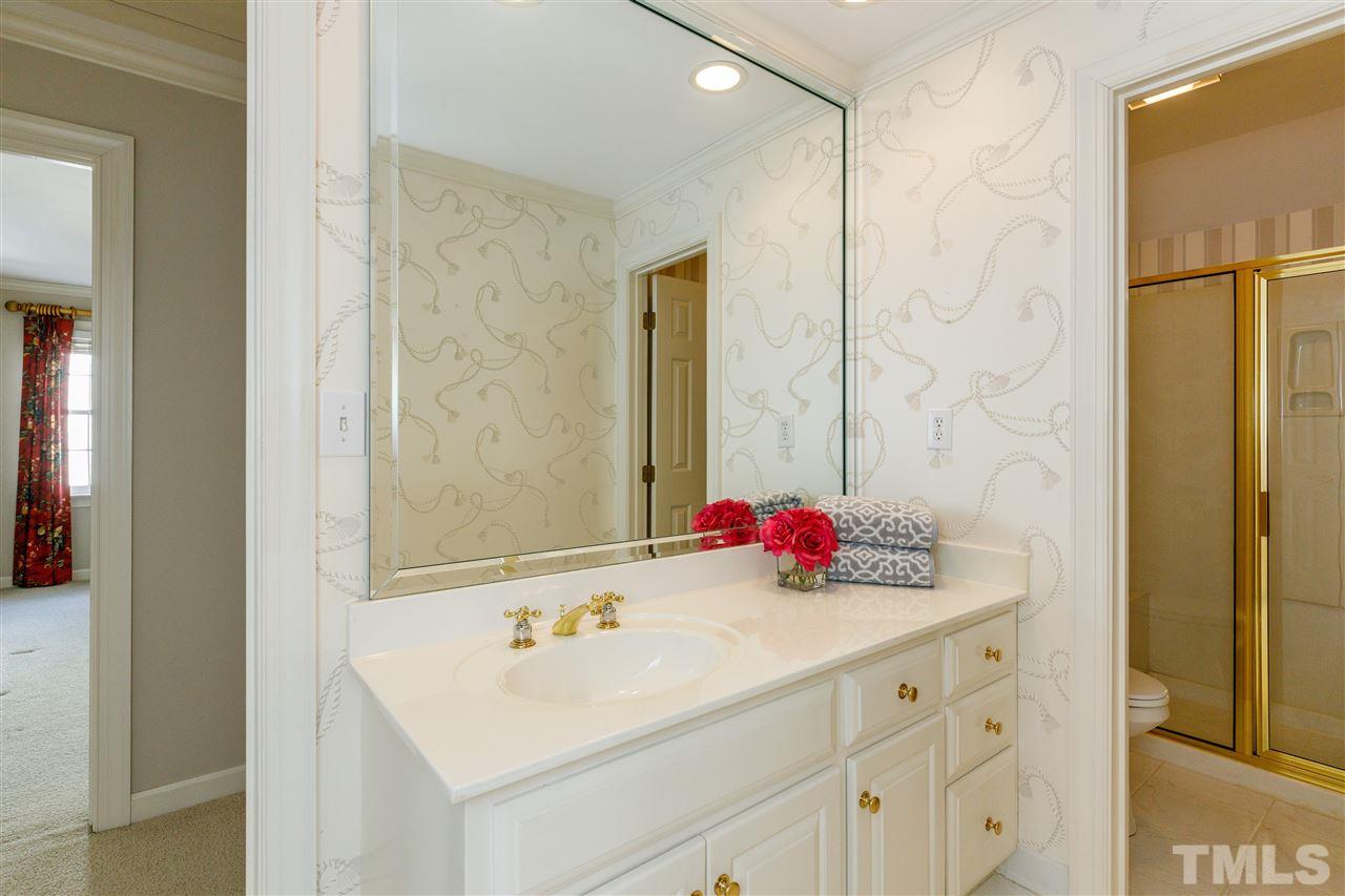 2968 Tillinghast Trail Raleigh, NC 27613 - Photo 21 of 28 a bathroom with a sink and a mirror