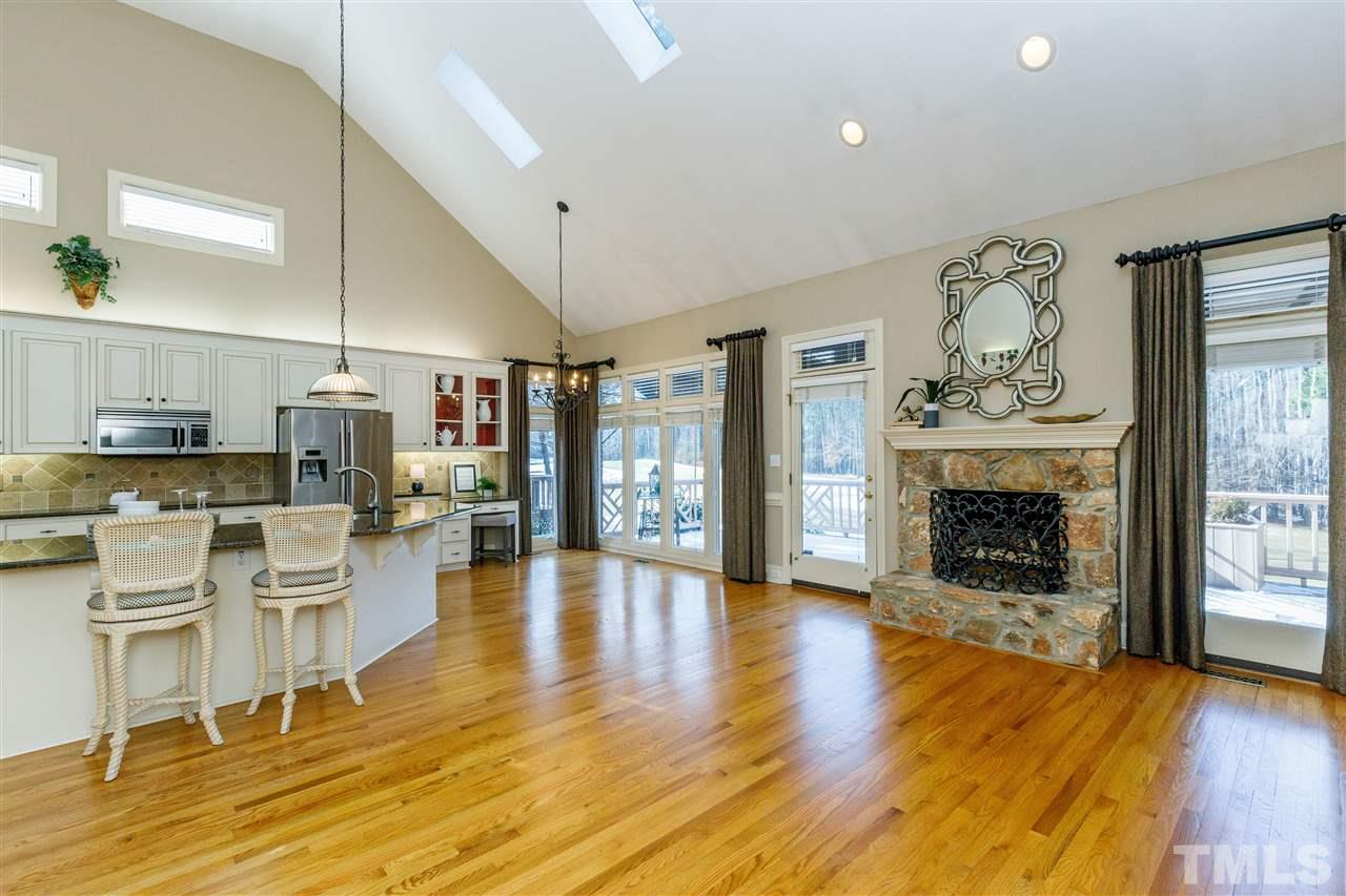 2968 Tillinghast Trail Raleigh, NC 27613 - Photo 6 of 28 a living room with furniture a fireplace and wooden floor