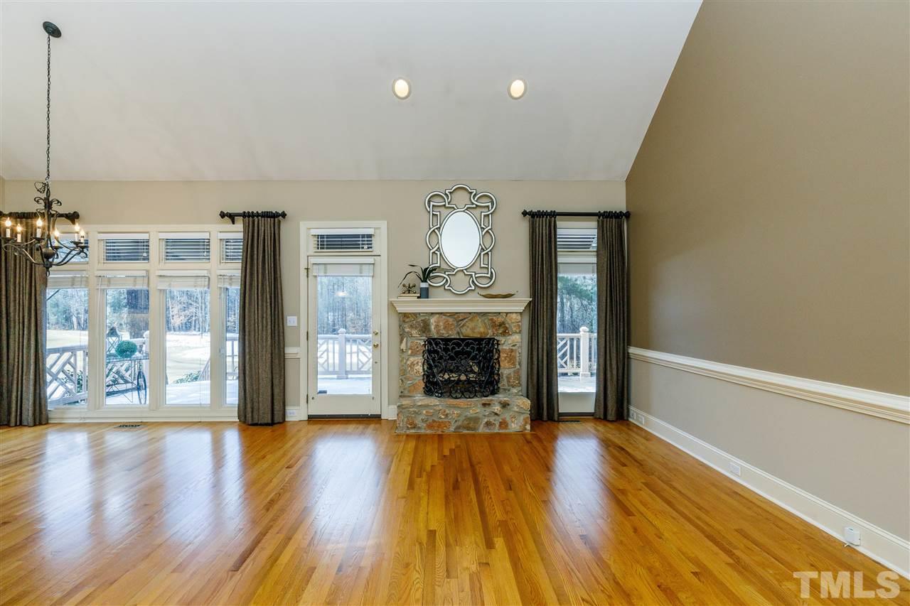 2968 Tillinghast Trail Raleigh, NC 27613 - Photo 9 of 28 a view of a livingroom with wooden floor a fireplace and window