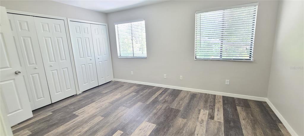 1304 Deer Springs Road Port Orange, FL 32129 - Photo 22 of 37 an empty room with wooden floor and windows