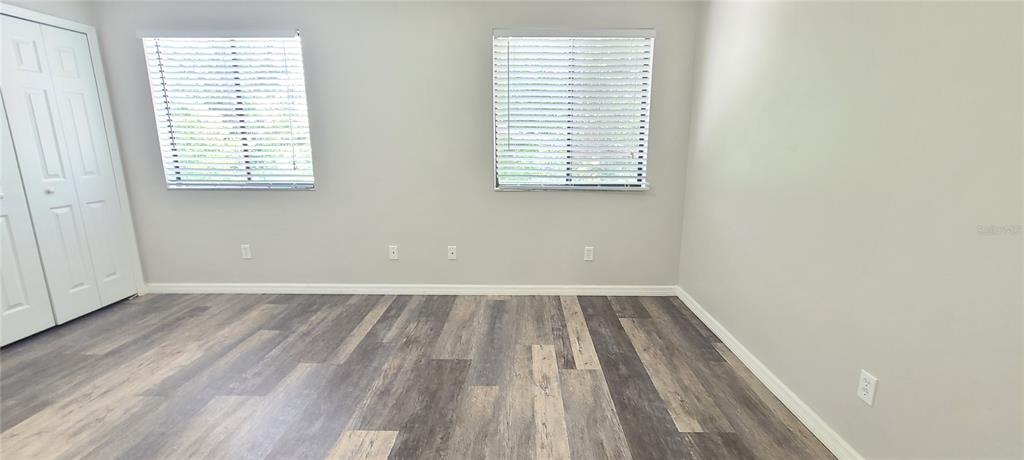1304 Deer Springs Road Port Orange, FL 32129 - Photo 23 of 37 an empty room with wooden floor and windows