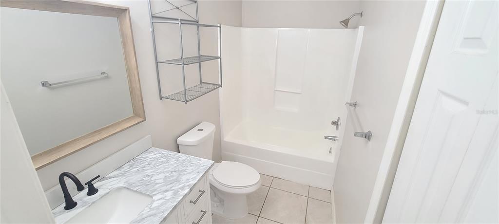 1304 Deer Springs Road Port Orange, FL 32129 - Photo 26 of 37 a bathroom with a granite countertop sink toilet and shower