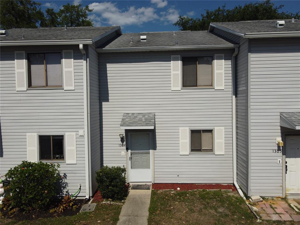 1304 Deer Springs Road Port Orange, FL 32129 - Photo 3 of 37 a view of a house with a yard and garage