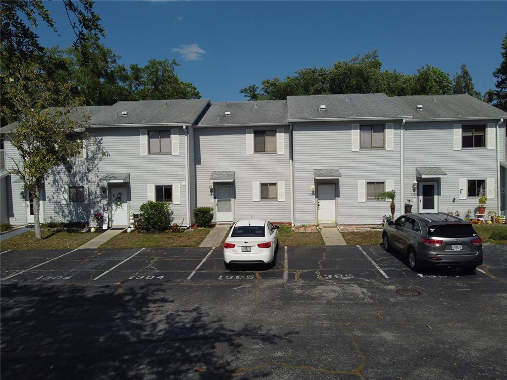 1304 Deer Springs Road Port Orange, FL 32129 - Photo 33 of 37 a car parked in front of a white house