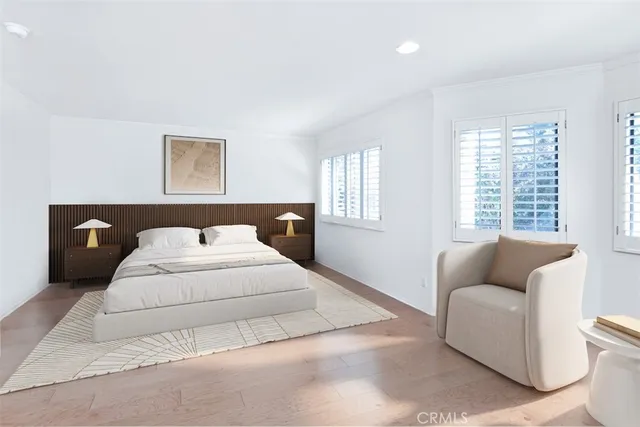 a bedroom with bed couch and window