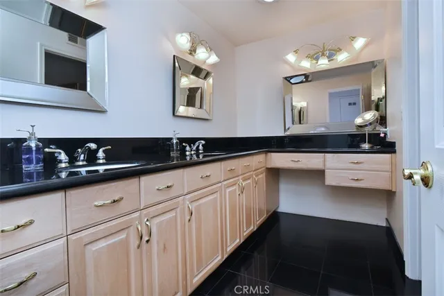 a kitchen with granite countertop a sink and cabinets