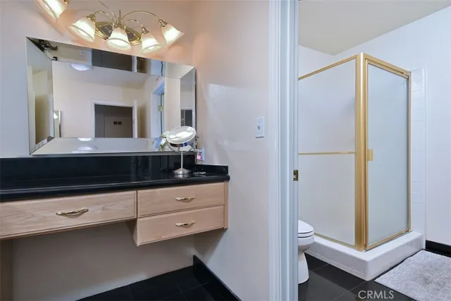 a bathroom with a sink a large mirror and a toilet