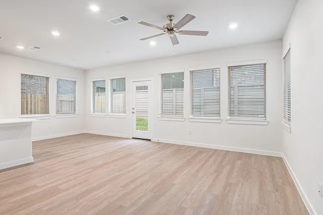 a view of kitchen with wooden floor and electronic appliances
