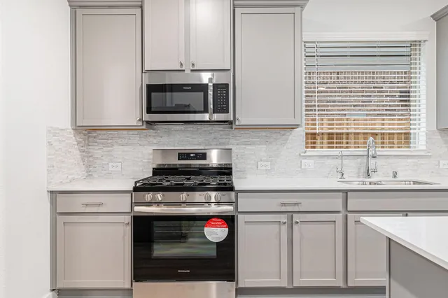 a kitchen with stainless steel appliances granite countertop a stove and a sink