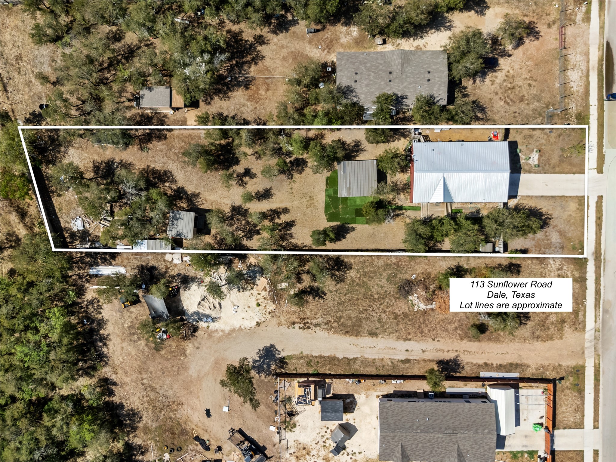 113 Sunflower Road Dale, TX 78616 - Photo 1 of 33 Mature trees surround this spacious property outline shown from a high-angle perspective.