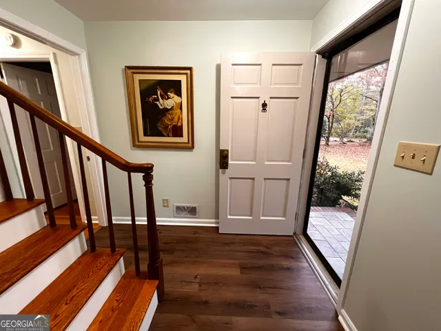 a view of an entryway with wooden floor