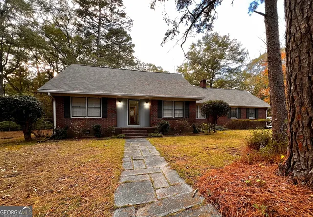 a front view of a house with yard patio and fire pit