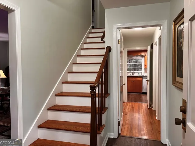 a view of entryway and hall with wooden floor