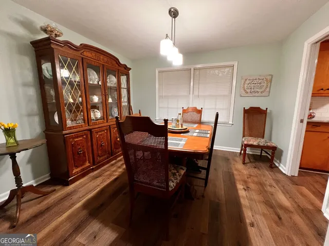 a view of a dining room with furniture window and wooden floor