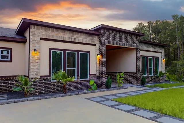 a front view of a house with garden