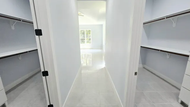 a bathroom with a granite countertop sink a toilet a mirror and shower