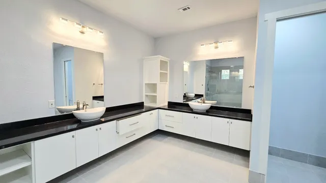 a bathroom with a sink a toilet a tub and shower