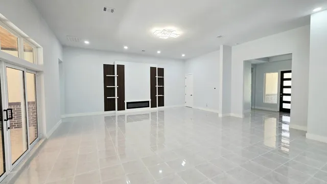 a kitchen with kitchen island granite countertop a sink a counter top space and living room view