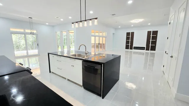 a bathroom with a tub a sink and glass door