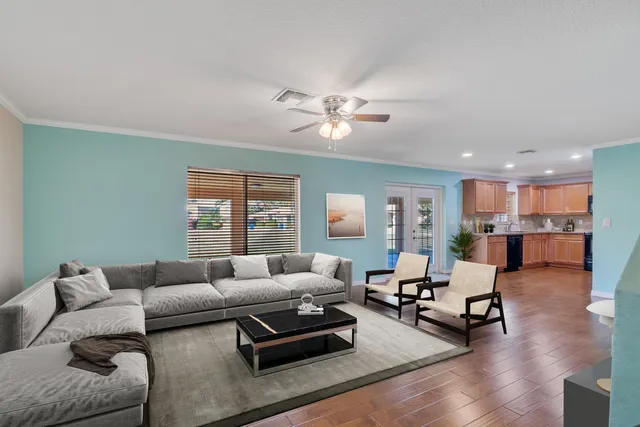 a kitchen with stainless steel appliances granite countertop wooden cabinets a stove top oven a sink and dishwasher