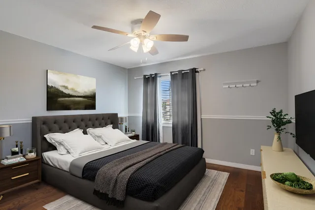 a bedroom with a large bed and a chandelier