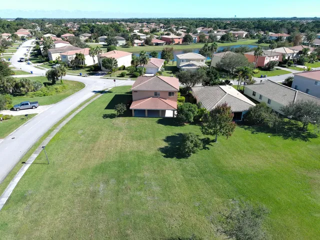 an aerial view of a house with garden space and lake view