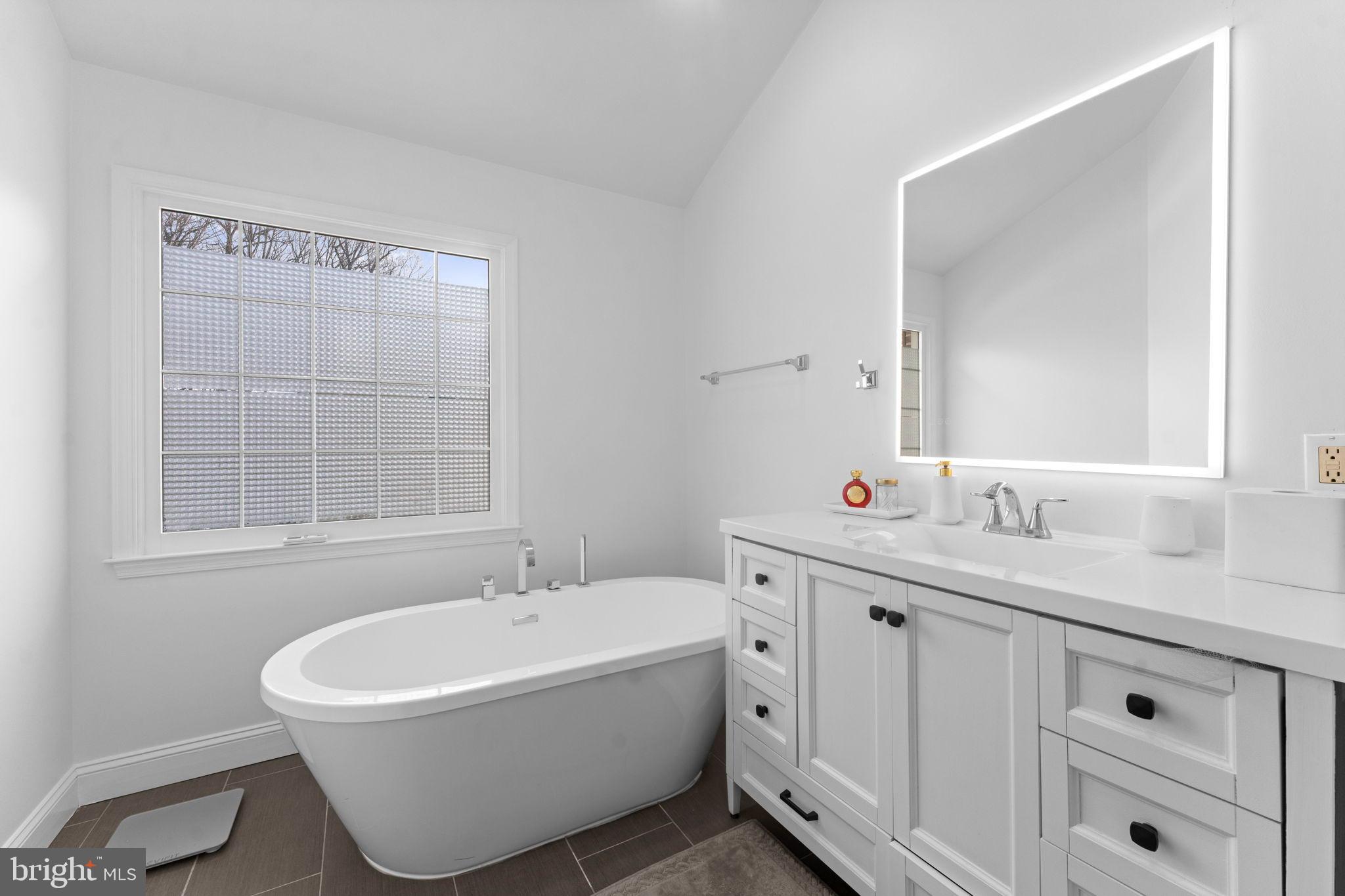 11433 Heritage Oak Court Reston, VA 20194 - Photo 22 of 47 a white bath tub sitting next to a white sink