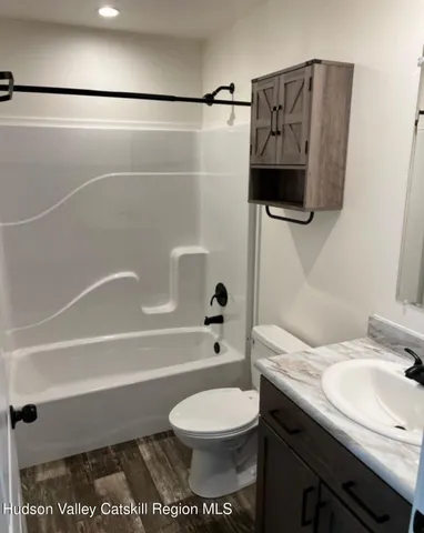 a bathroom with a toilet a sink and bathtub