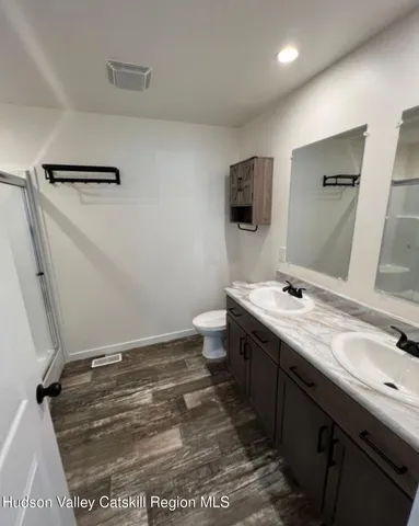 a bathroom with a sink a toilet a mirror and vanity