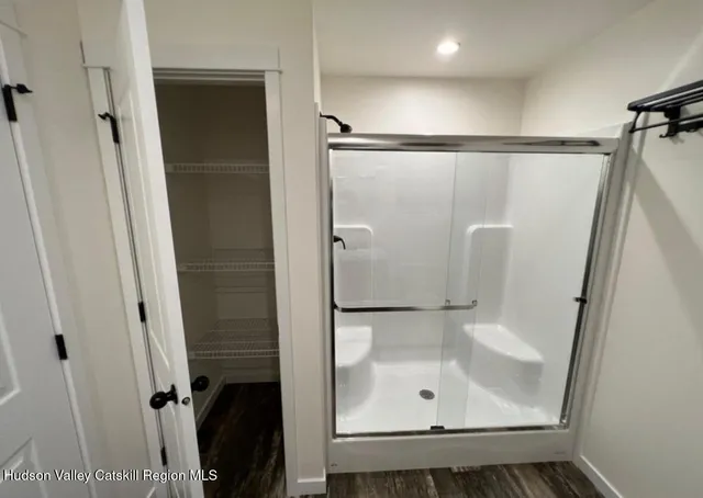 a bathroom with a shower and a sink