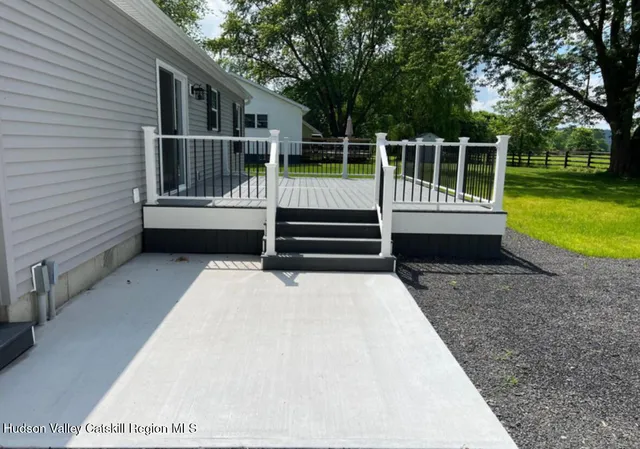 a view of a deck with a large trees