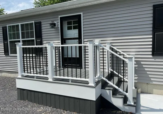 a view of a house with wooden fence