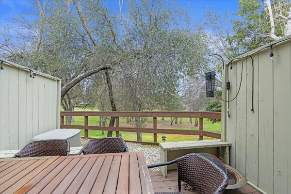 a view of a chairs and table in a balcony