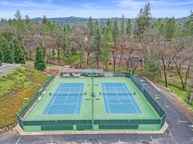 an aerial view of a houses with a lake