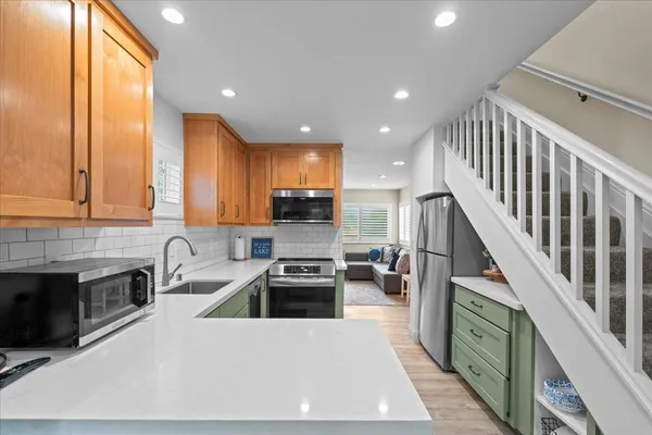 a kitchen with sink cabinets and stainless steel appliances