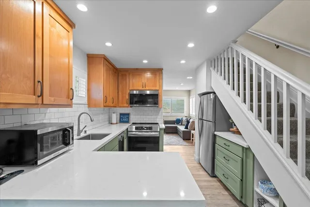 a kitchen with sink cabinets and stainless steel appliances