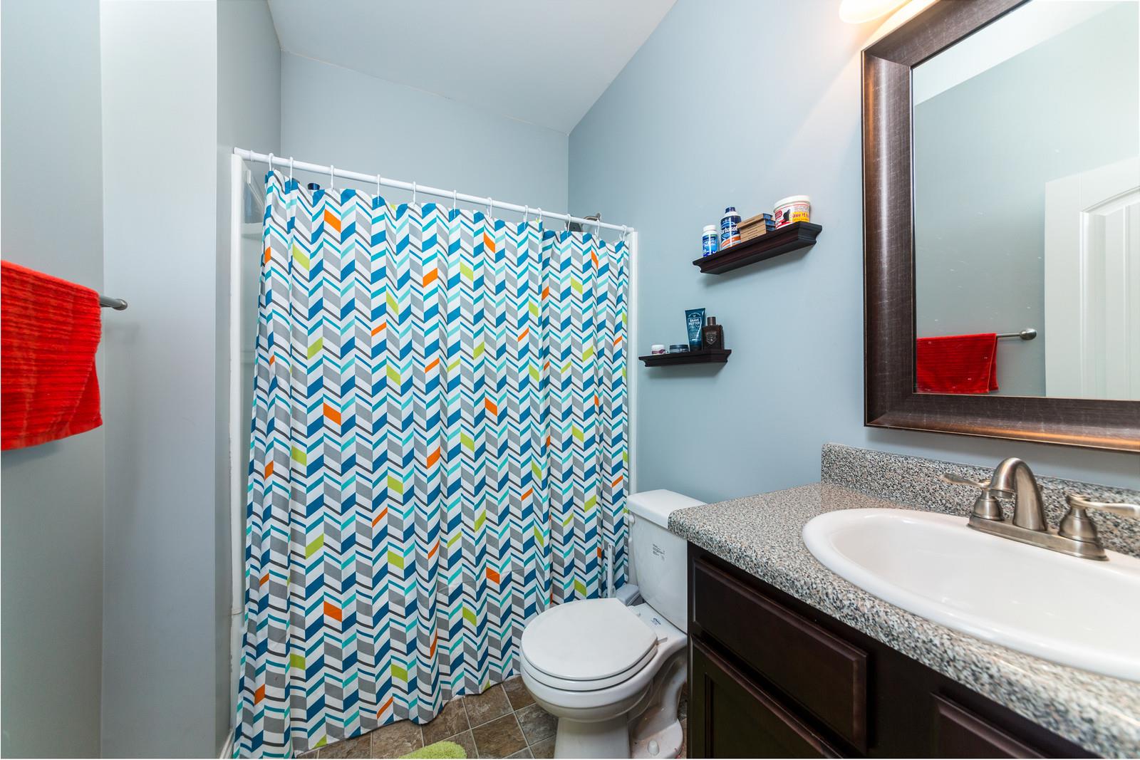 2340 Pea Ridge Road Clarksville, TN 37040 - Photo 12 of 25 a bathroom with a granite countertop toilet a sink and a mirror