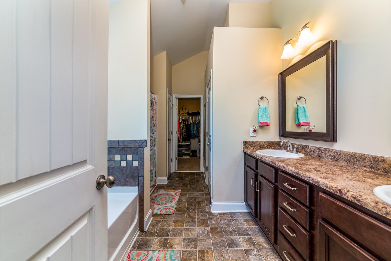 2340 Pea Ridge Road Clarksville, TN 37040 - Photo 20 of 25 a bathroom with a granite countertop sink a mirror and a bathtub